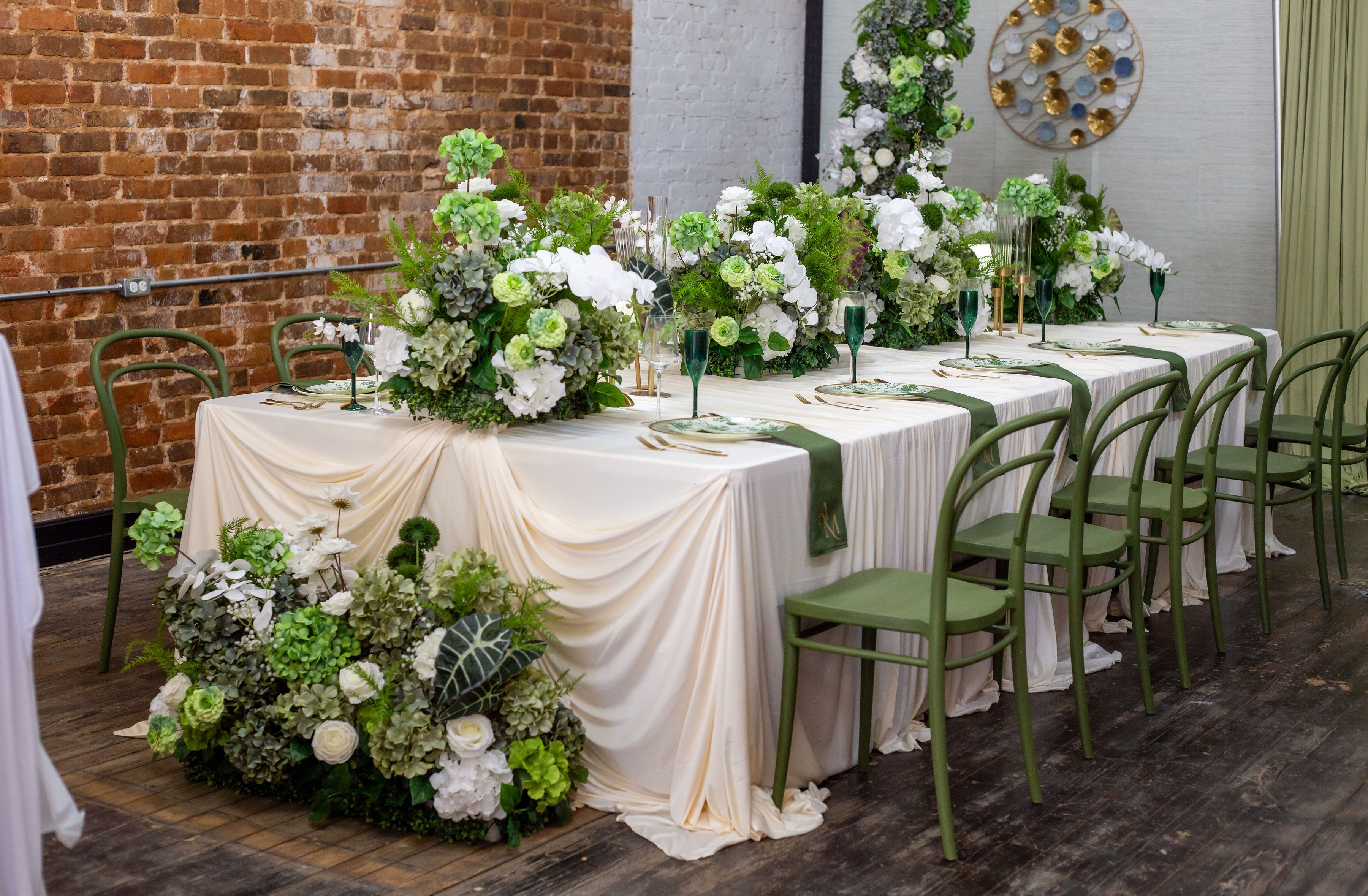 3 flowers placed in a vintage glass jar with a soft green background.